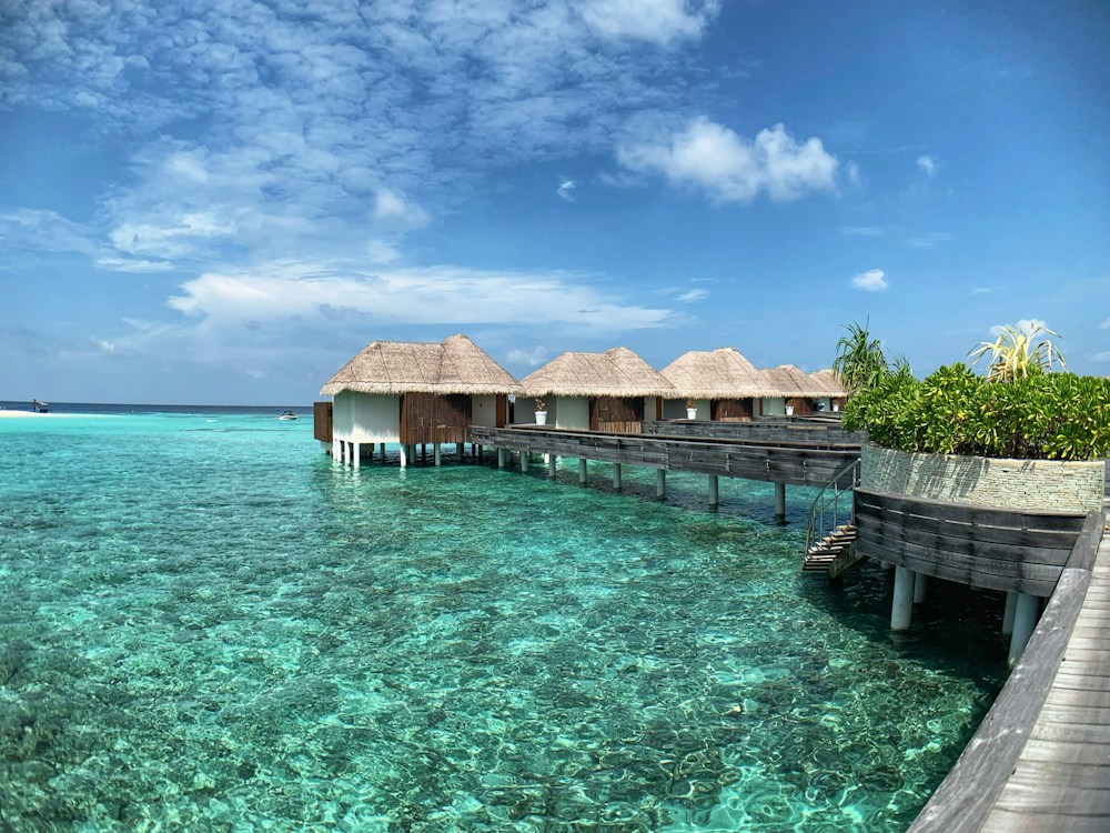 Thatched overwater villas and a timber walkway in the Maldives